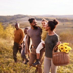Family walking in a field. 